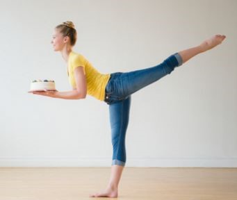 A dancer holding a birthday cake